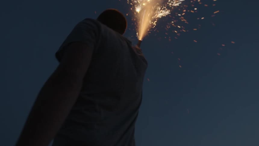 Man holds a flare in the air