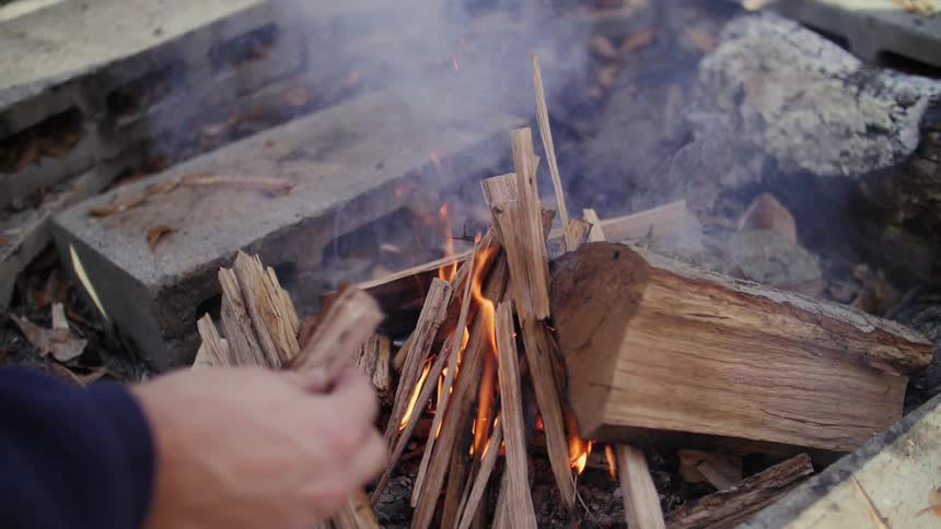 Kindling is being added to a fire