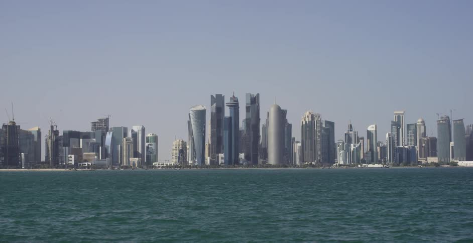 Ocean water ripples in front of city skyscrapers