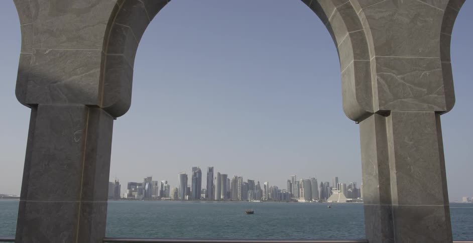 The ocean and city skyline viewed through and outdoor archway