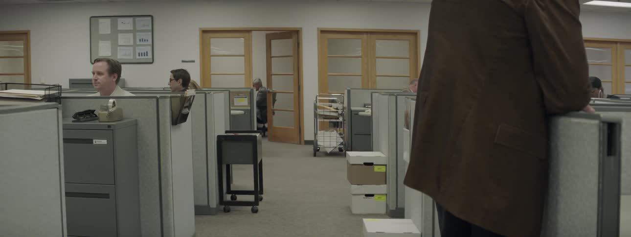 People work in cubicles in an office