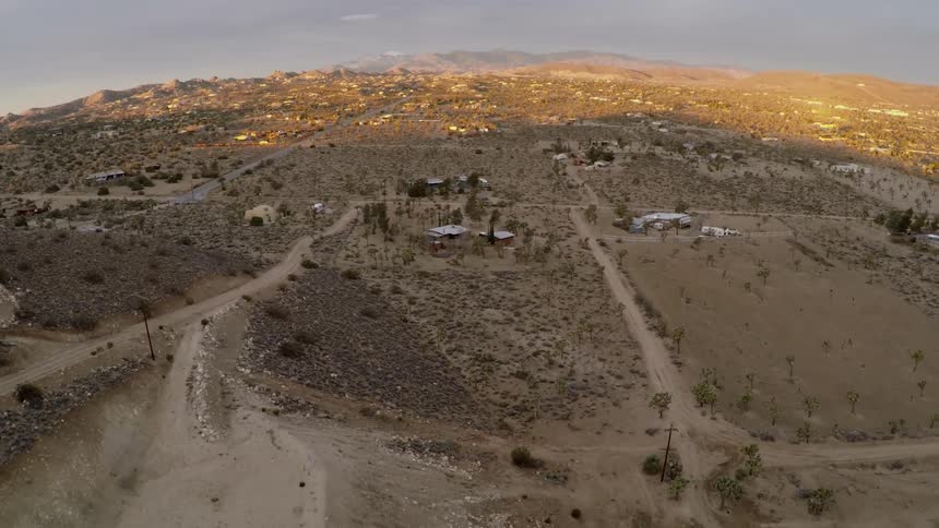 Dirt roads houses and trailers in a desert landscape