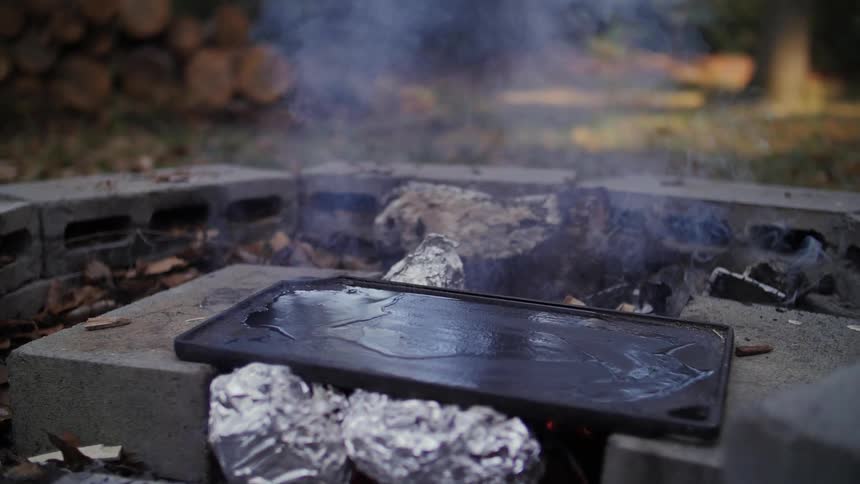 Smoke rises from a makeshift fire pit