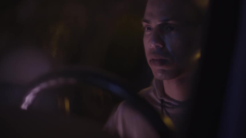 A man looks back in his vehicle
