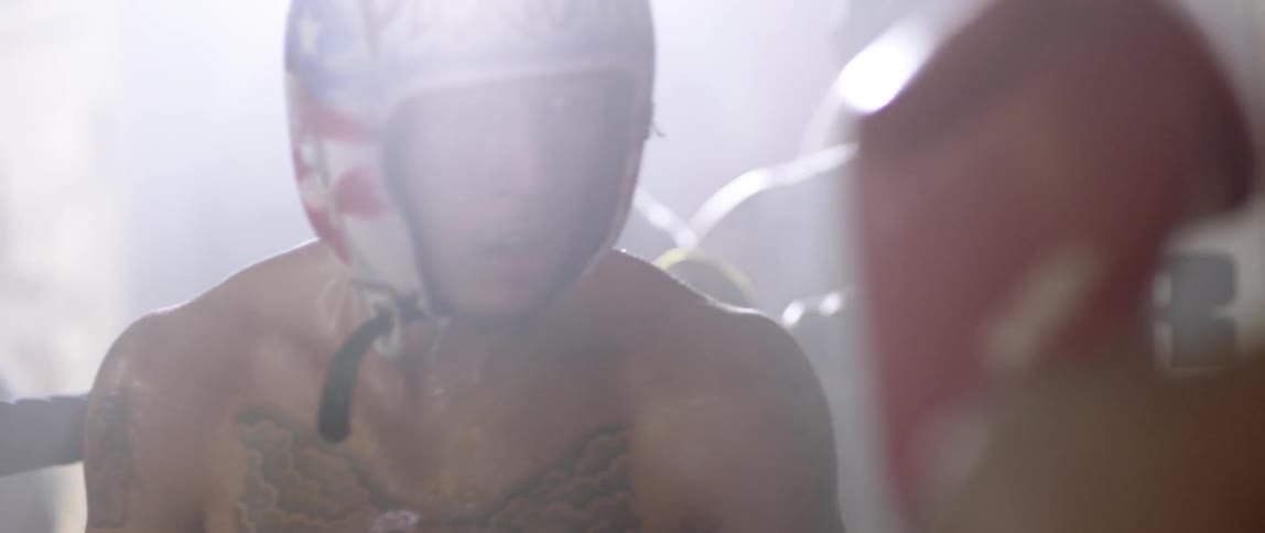 Two boxers fighting as others watch on