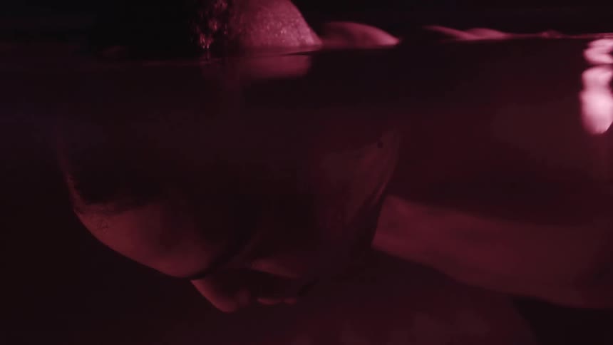 A boy floats with his face down in the water