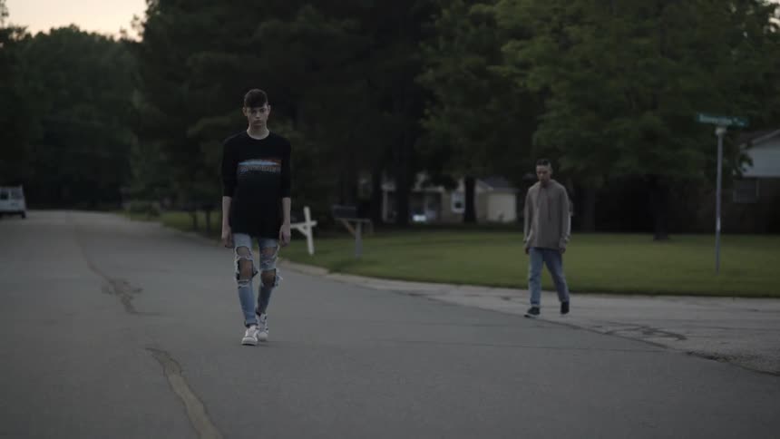 Teenage boys walk on a neighborhood street