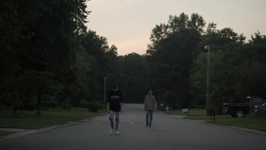 Two teenagers walking down the street on a cloudy day