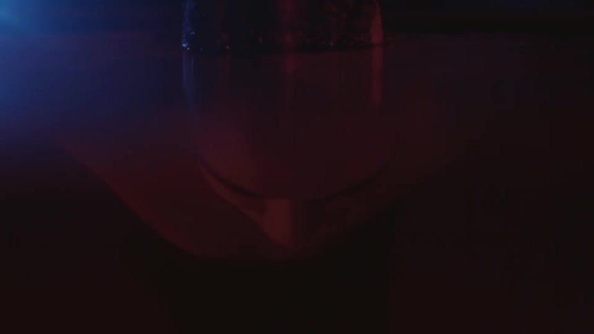 A man rises out of the water at night