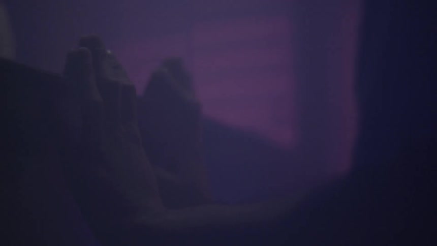 A man has his hands on a wall