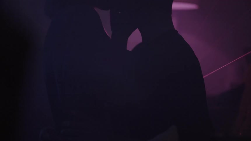 A couple kissing at a nightclub