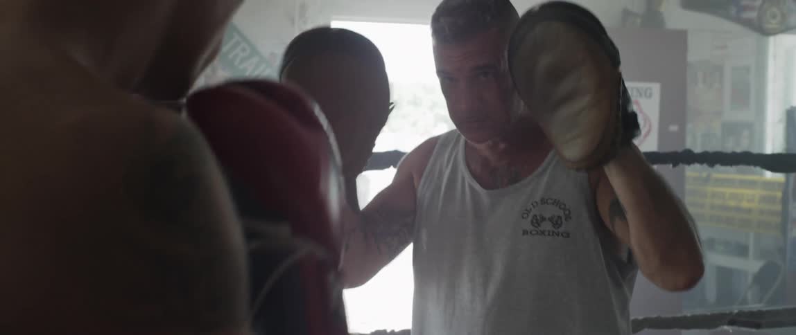 Boxer training with a partner inside the ring in a gym