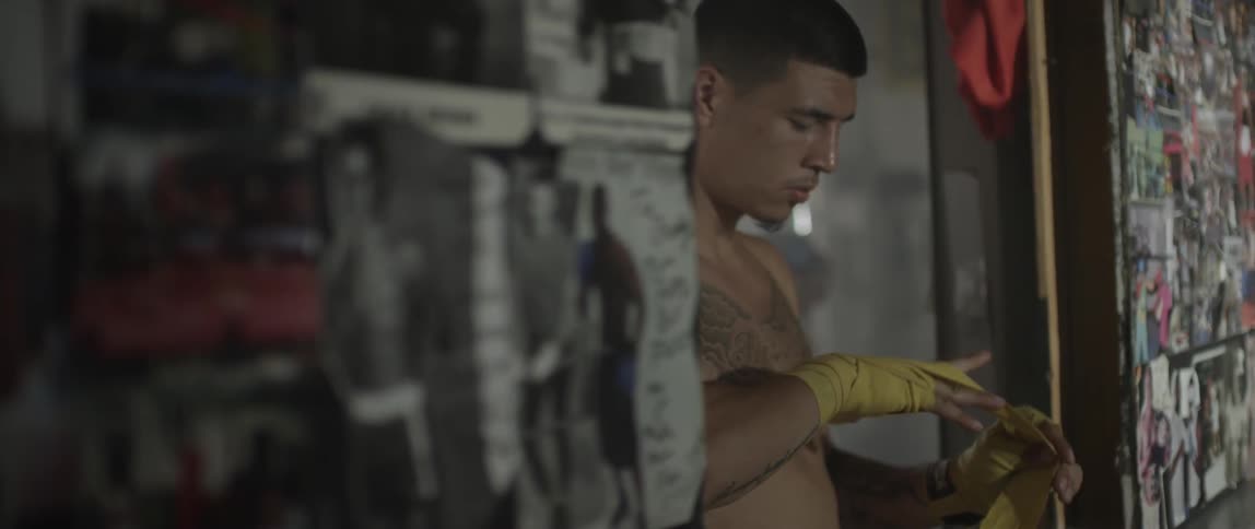 Athlete wraps his hands in yellow tape
