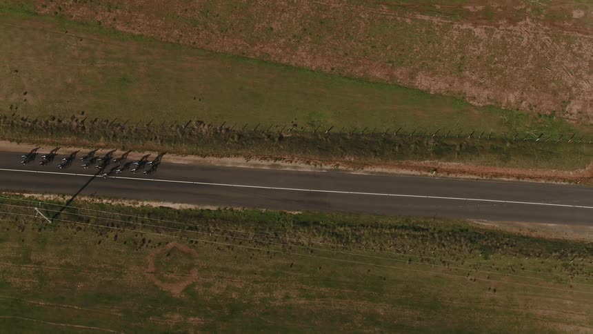 A group of cyclists ride down the road