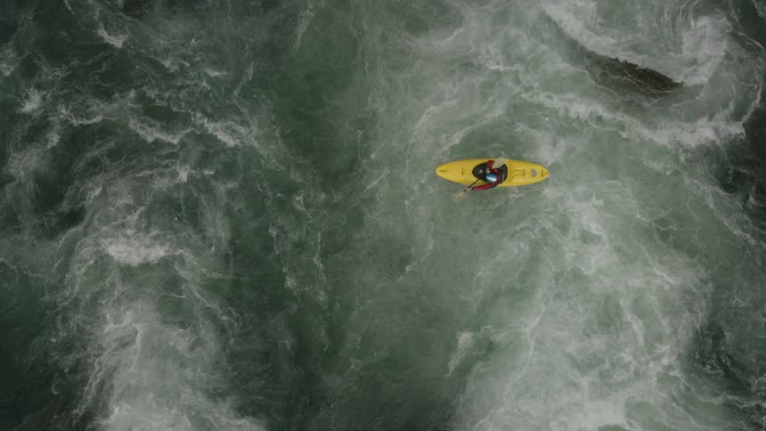 Aerial view of two people kayaking down a river