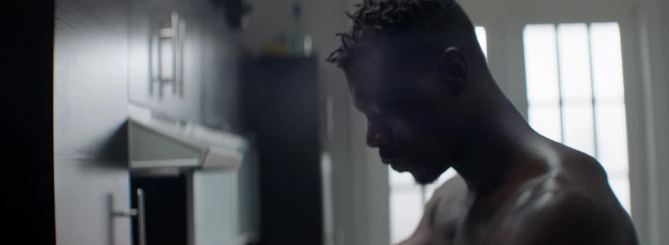 A man is standing in his kitchen