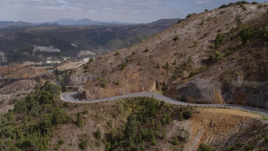 A road winds up the side of a mountain