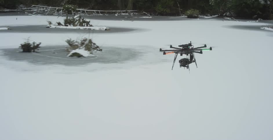 Small object flying over an iced-over body of water