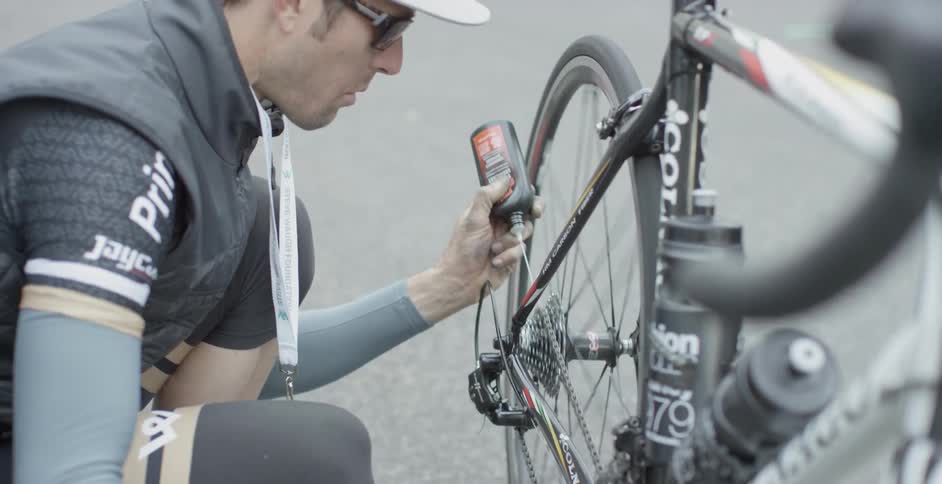 A man oils his bike chain