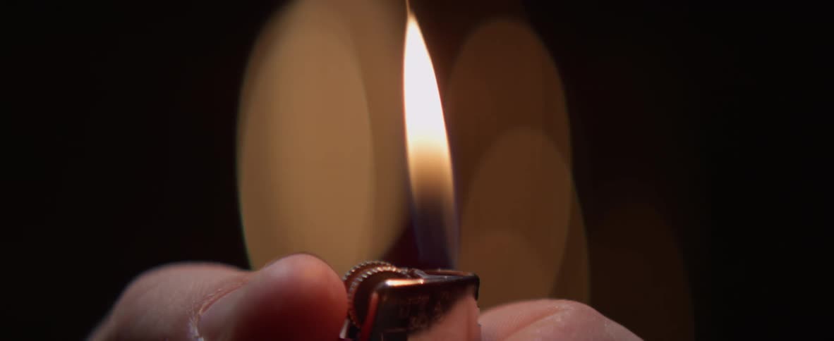 A flame pops up from a cigarette lighter