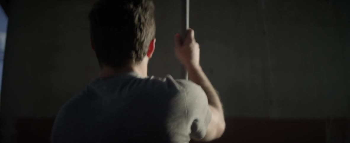 Man tosses a ball with a lacrosse stick