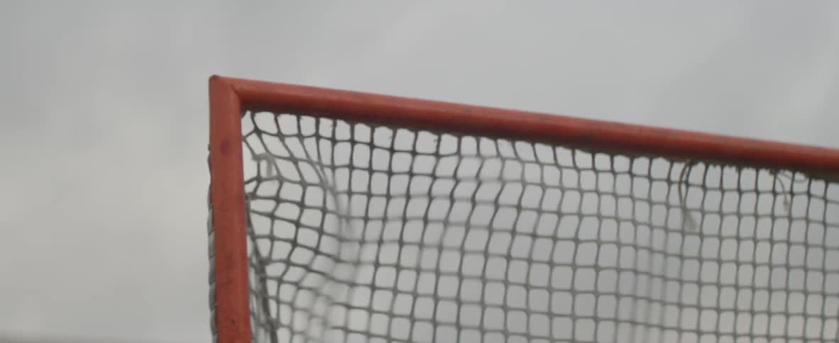 Ball striking a net on a cloudy day