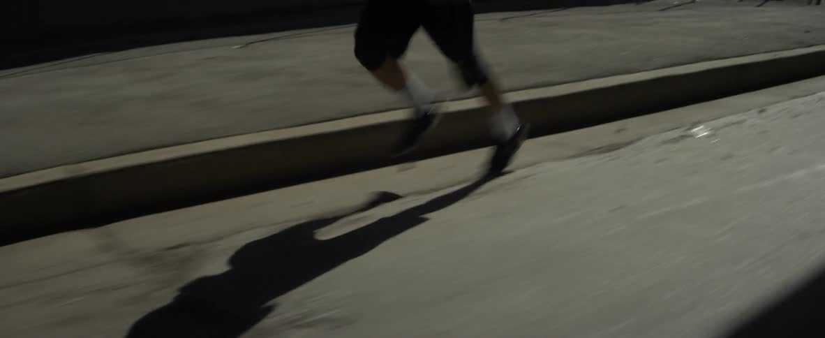A man jogs outside on a street