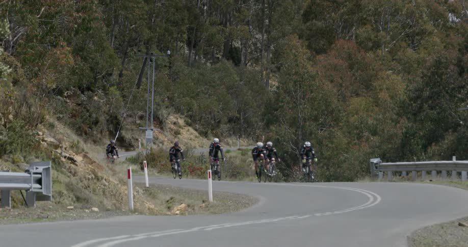 A group of cyclists travelling down the road