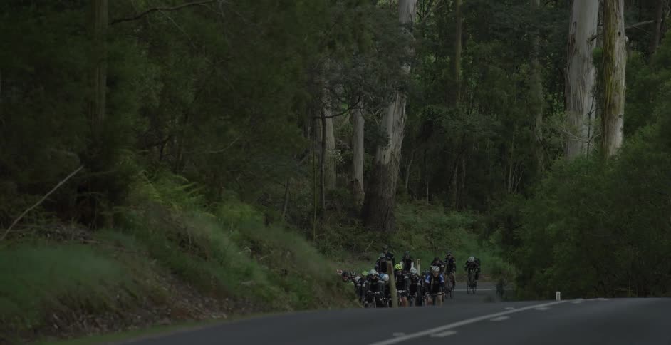 White truck passes a group of cyclists