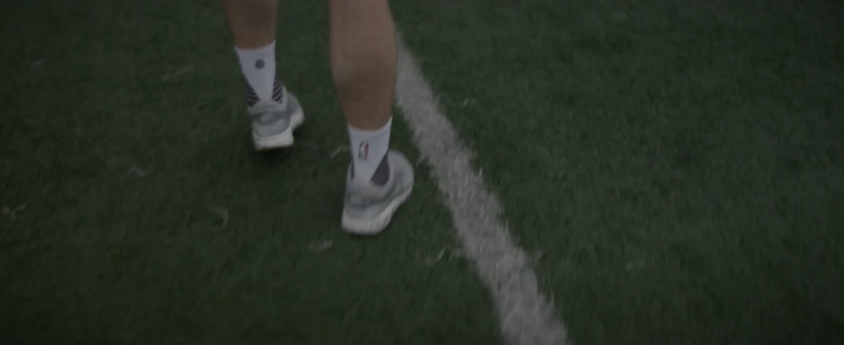 Man practicing his lacrosse game on a field