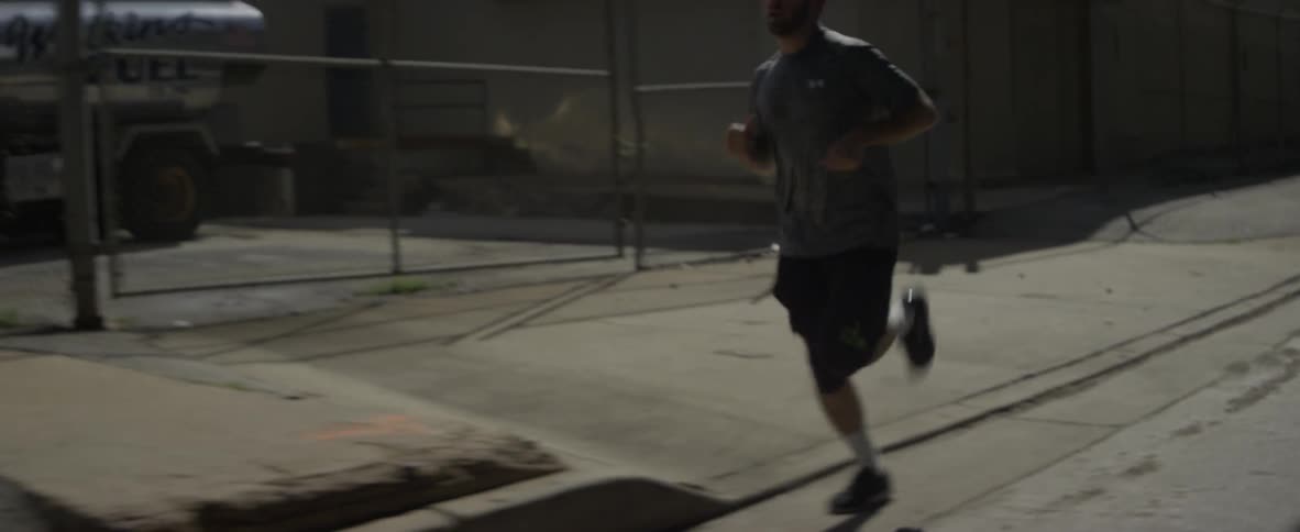 A man jogs on a city street