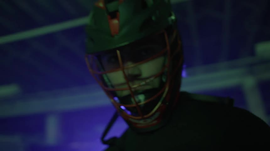A man is looking down wearing a sports helmet
