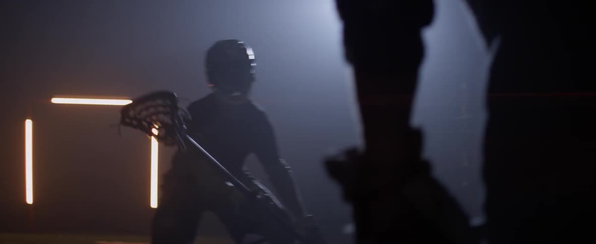 Two men are playing lacrosse indoors