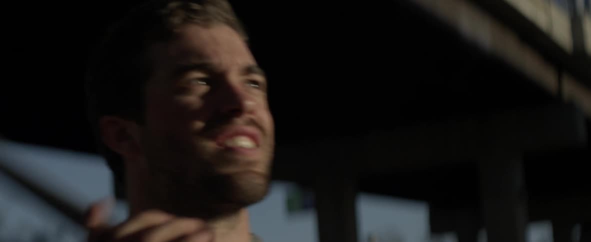 A man is repeatedly throwing a ball using a lacrosse stick