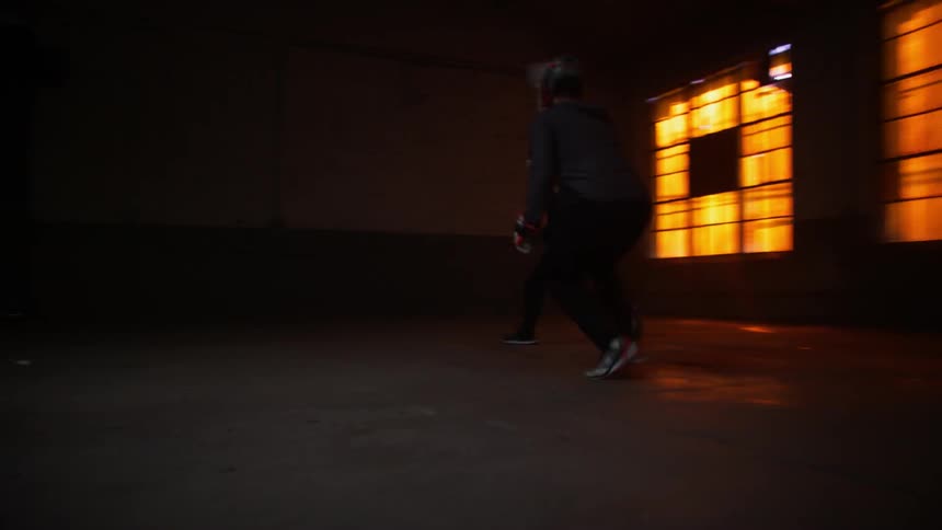 A group of people play lacrosse indoors