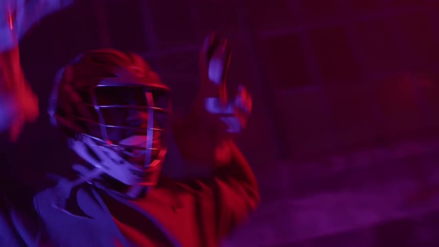 A lacrosse player cheers pumping his arms up and down