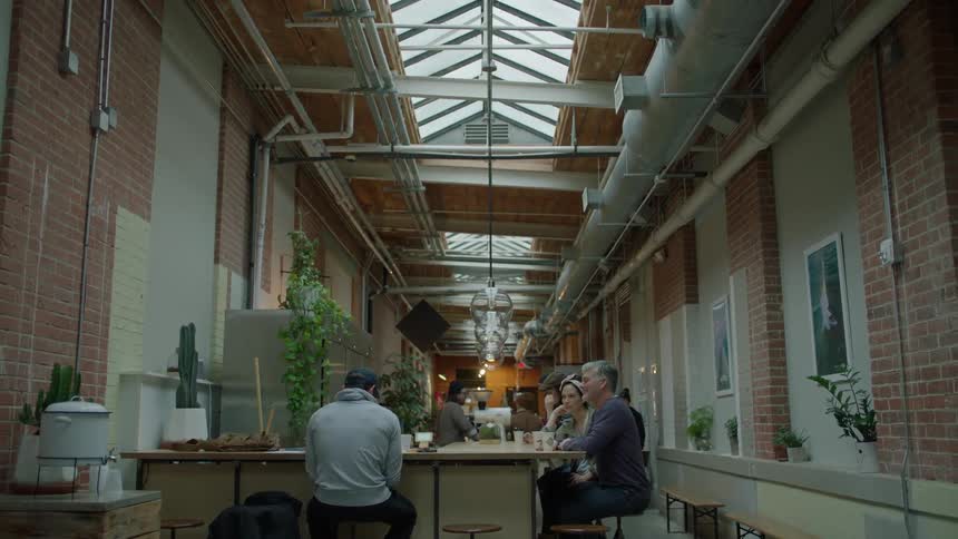 People sit around a restaurant drinking, and eating
