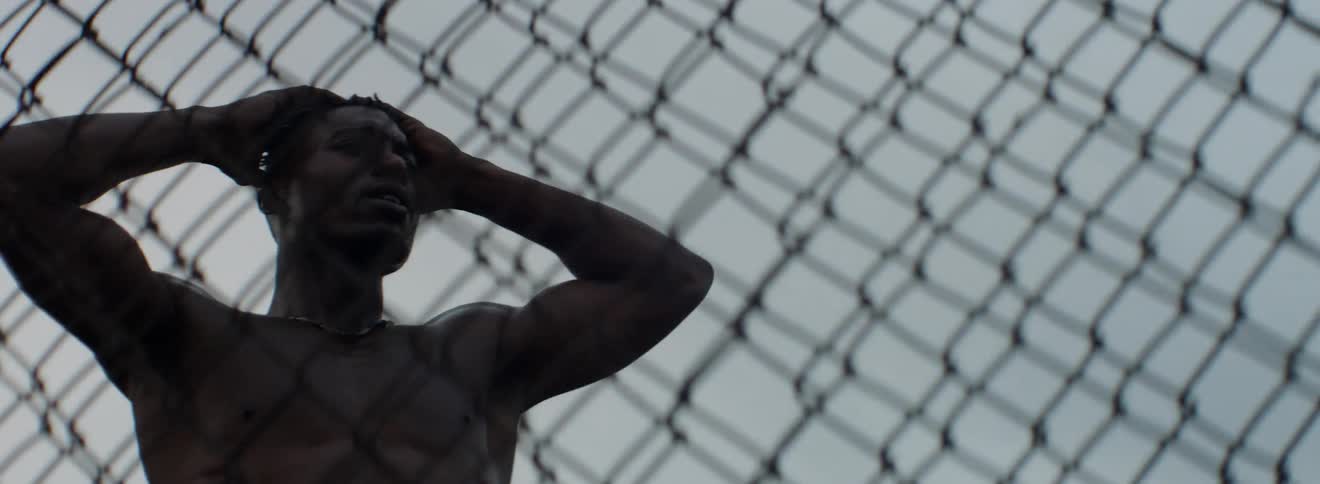 A running man slams into a chain-link fence then walks away