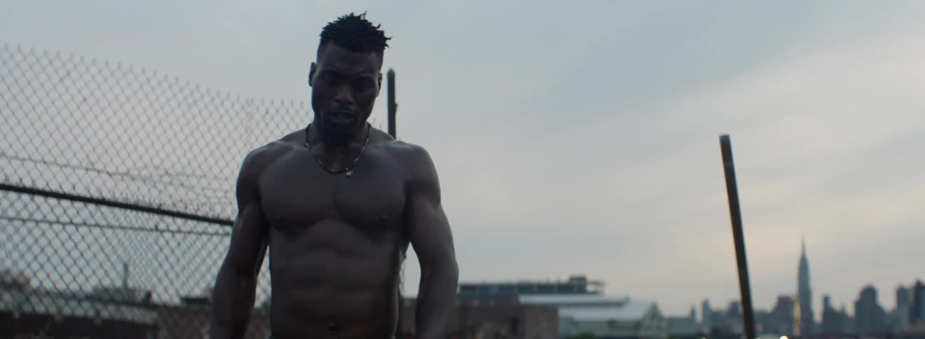 A male athlete walks around as he catches his breath