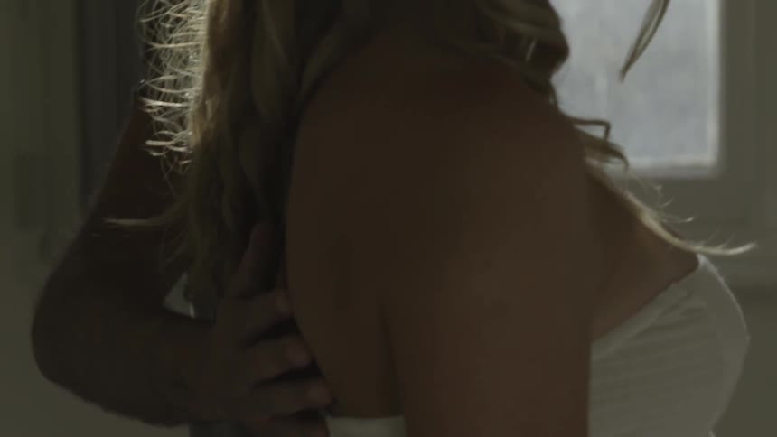 A man rubs a woman's shoulders