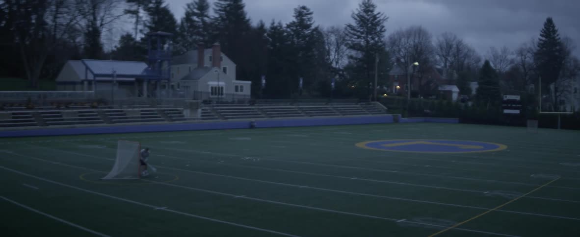 A person is on the field playing by the net