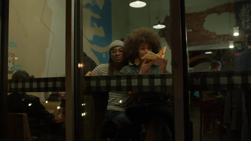 People laughing and eating in a restaurant