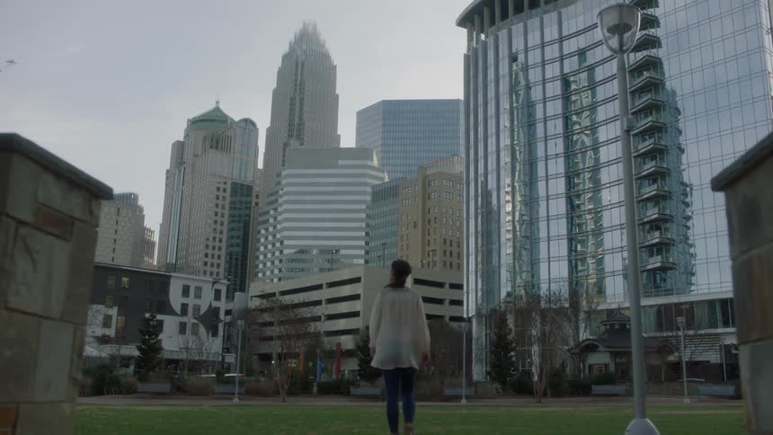 A woman walks in a city park