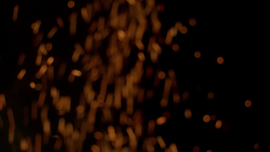 A fire is giving off sparks at night