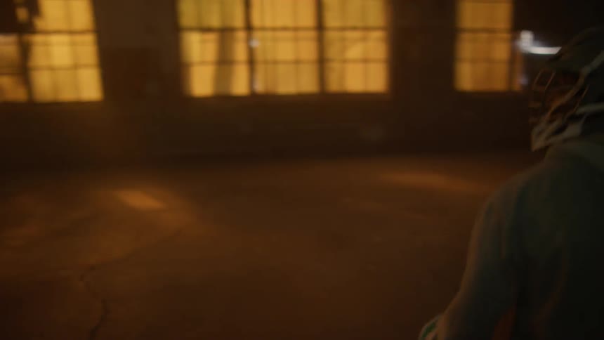 Lacrosse players play in an empty warehouse