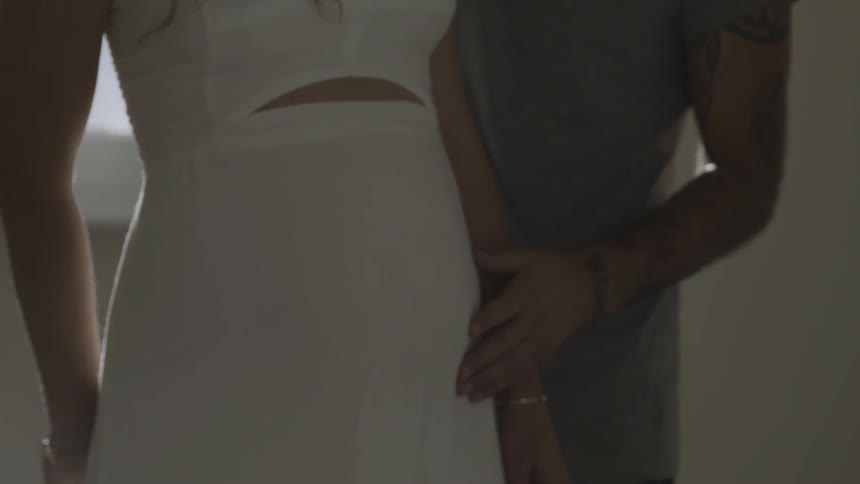 A man rubs a pregnant woman's belly