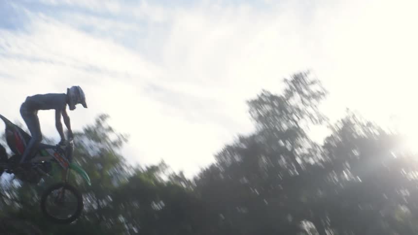 A dirt biker jumps off a high hill