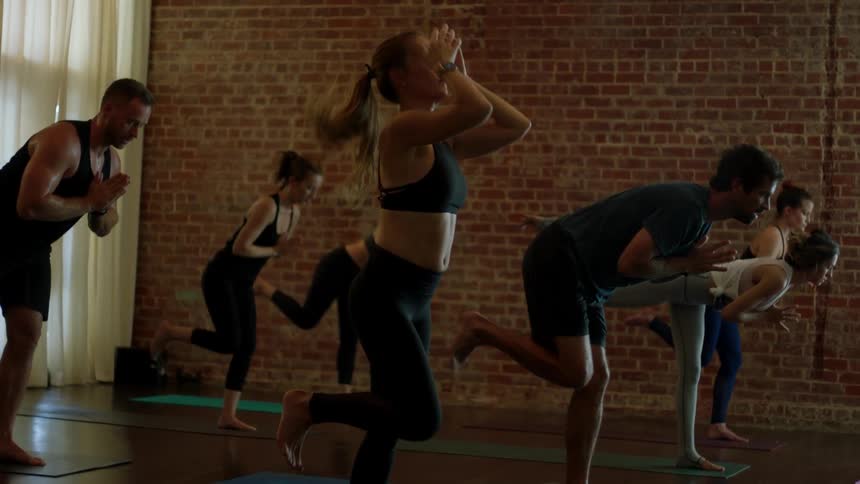 Men and women practicing yoga in a studio