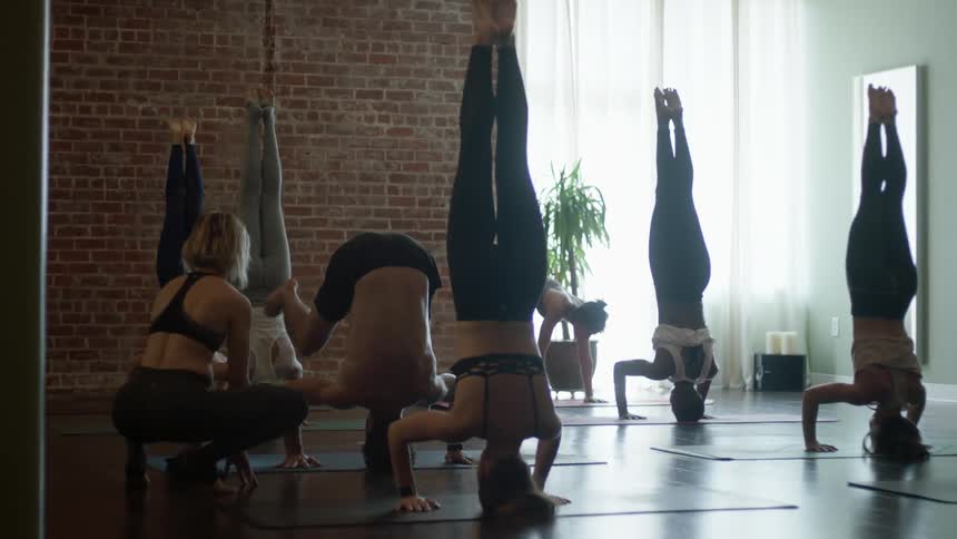 Women perform yoga in studio