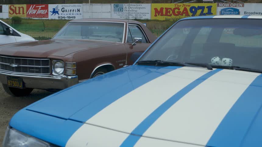Vintage cars are parked in this lot